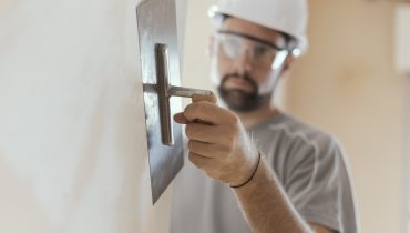 Professional craftsman applying plaster with a trowel