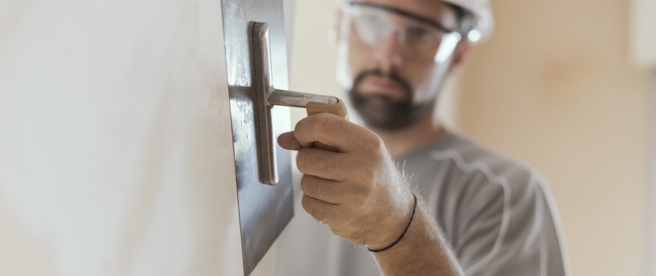 Professional craftsman applying plaster with a trowel